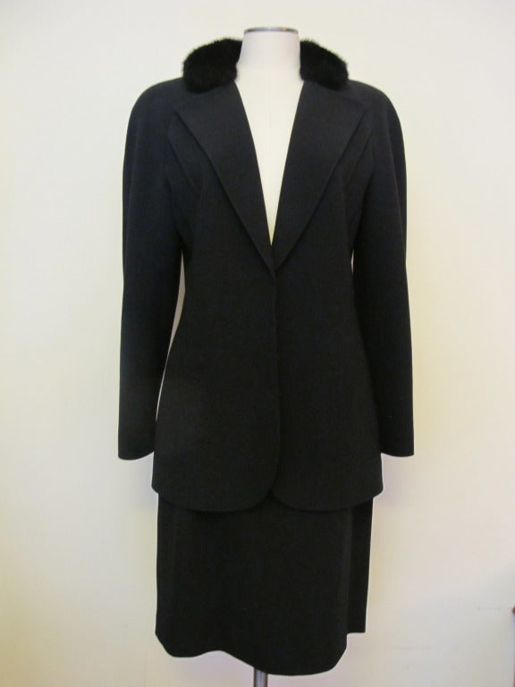 Chic black Valentino suit; jacket enhanced with black mink collar. When collar is standing up the back of the collar is also black mink. Skirt waist 28 inches, Hips 40 inches, Skirt length 23.25 inches, Jacket length 27.5 inches, Jacket sleeve