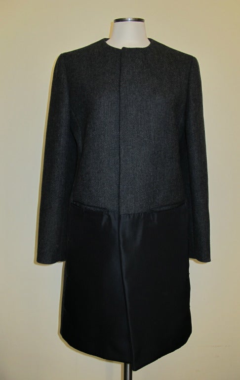 Elegant coat which closes through invisible magnetic discs. Black Satin paneled insets adorn the front of the coat. Sleeve length 24.5 inches, Shoulder to shoulder 17 inches