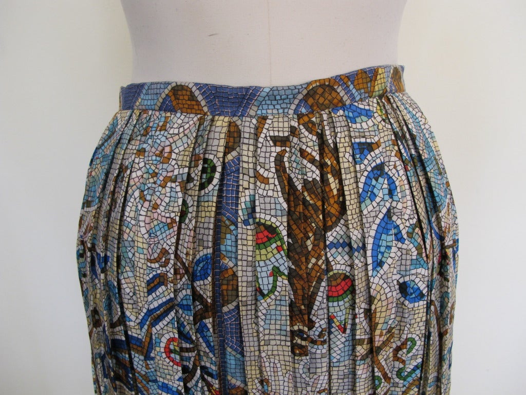 Elegant Hermès Pleated Mosaic design skirt with deer, flowers and trees seen throughout piece.