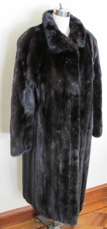 Natural split skin male let out full length ranch mink coat.
Stand-up wing collar with button closure 
1 row full fur facing set in sleeve with fur turned back cuff
64 inch sweep. Sleeve length 29.5 inches.