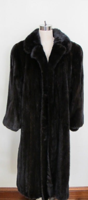 Natural all female let out vertical striped full-length ranch mink coat set-in bloused sleeve with cuff double fur notched collar; 1 row full facing. Timeless Fashion. Sweep 66 inches. Sleeve length 28 inches. Shoulder to shoulder 20 inches. Length