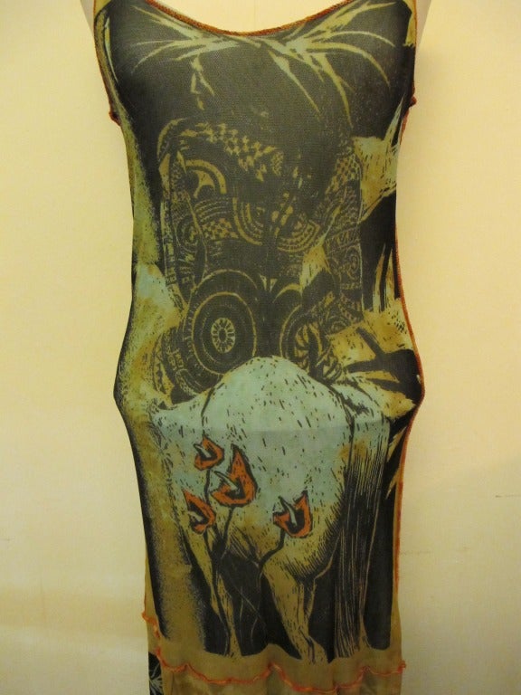 Iconic Gaultier dress enhanced by design of indigenous person riding horse with tropical background. The dress is lined with stretchy net. The fabulous piece can fit sizes 2 to 6 due to the stretch of the fabric. The tank top fits beautifully.