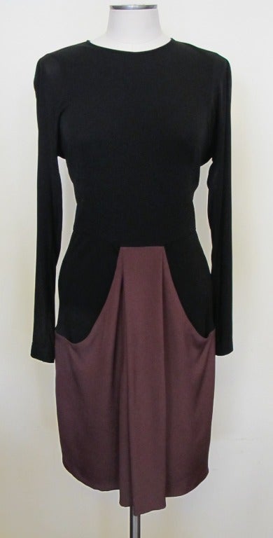 Fabulous Akris dress prefect for day or evening event. Fabric stretches and in the Akris tradition the dress lends itself to a perfect fit. The maroon drape in front and back of dress accentuates the overall elegant look. The drop shoulder fits the