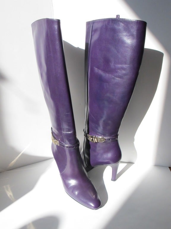 New Gucci luscious purple boots with silvery gold Gucci buckle on the sides with 3.5 inch heels. These boots measure 19 inches from the top to bottom and 14 inches around calves.