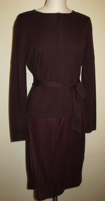 Maroon sweater jacket with zipper and matching leather skirt. The outfit is meticulously crafted. The skirt is created with sewing 1/4 inch leather strips and forms a straight skirt. Skirt is lined with silk organza. Length of jacket measures 23
