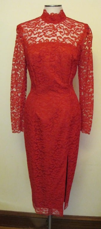 Stunning red lace fitted dress with long fitted sleeves. There are two slits, front slit measures 17.5 inches and the back slit has a 16 inch opening. The Mandarin collar measures 2 inches. Sleeve length measures 23.5 inches. Shoulder to shoulder