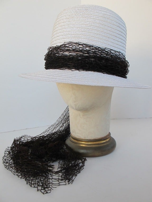 Joseph Magnin White Straw hat with glamorous fine silky, nylon netting. Measurements within hat is 22.25 inches.