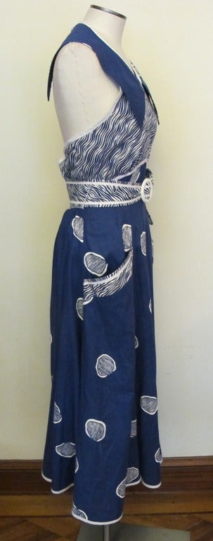 Chic Blue and White Halter Jeanne Marc dress. Halter back has elastic waist. Belt length is 39 inches long by 2.75 inches wide, accentuated by piping: there are 8 white buttons in back of skirt cascading from waist to hem. Two large pockets adorn