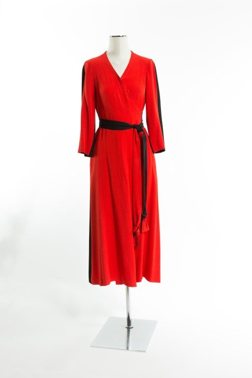 Dramatic floor length black and red-orange belted long-sleeved gown; red-orange front, black back with two tone belt. Size 4-6. Fabulous!! May be worn as a hostess gown or as an evening dress. Surely a dramatic entrance for your next