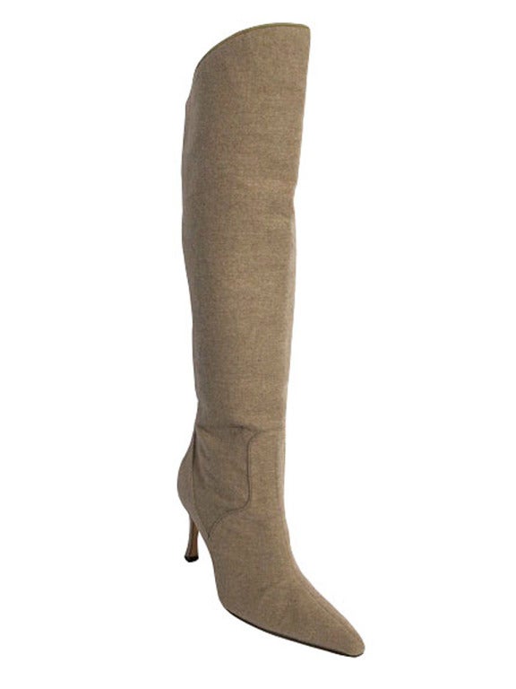 These luxurious taupe cashmere Manolo Blahnik over the knee boots are a chic staple to add to your fall wardrobe. The shaft of these boots measure 15.5" behind the knee and 18" in front of the knee, hitting just above the kneecap. These