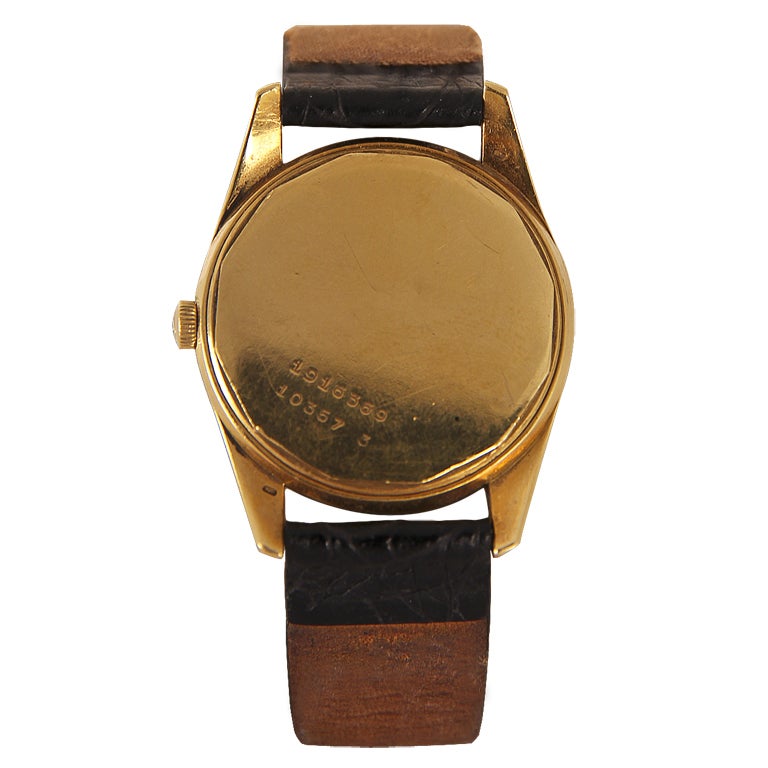 Rose gold case, black dial with gilt hands and applied hour markers. 215 caliber automatic movement, central sweep seconds hand. Applied Universal signature with logo.