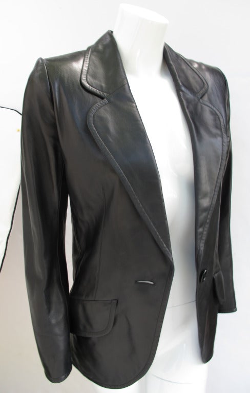 A 1990 Yves Saint Laurent Haute Couture jacket/blazer made from buttery soft black leather. With a slim-fitting silhouette, two front flap pockets, a single button closure and lined in silk charmeuse - the jacket is a testament to Yves Saint