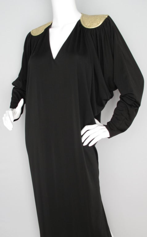 Nothing says the '70's like this loungey caftan from Bill Tice. Draped to perfection with dramatic batwing sleeves and a sexy side slit - the standout design element is gold lame quilting at the shoulders forming a yoke at the back shoulders and