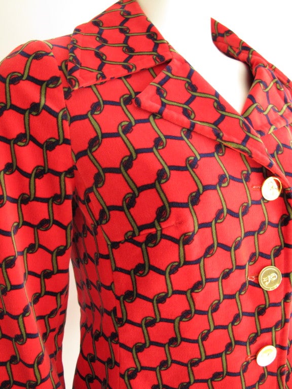 1970's Roberta di Camerino red velvet jacket featuring a pattern of interlocking green and black chain. The jacket is fully lined, has invisible pockets sewn into the front seams and closes down the front by means of six goldtone 