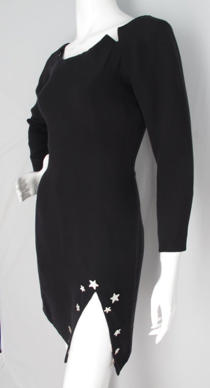 1988 Geoffrey Beene black silk dress featuring a knee-high slit adorned with mother-of-pearl stars. Constructed out of two layers of silk with the neck, cuffs and hem lined with silk charmeuse in a pattern of sun, moon and stars. And zippers at the