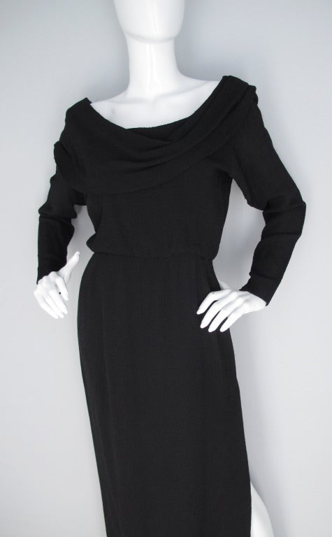 1990's Yves Saint Laurent wool/silk blend black gown with draped neckline and dramatic side slit. Zipper closure runs up side of body and finishes at arm seam. Size 38. In excellent condition.
MEASUREMENTS:
Shoulders - 16