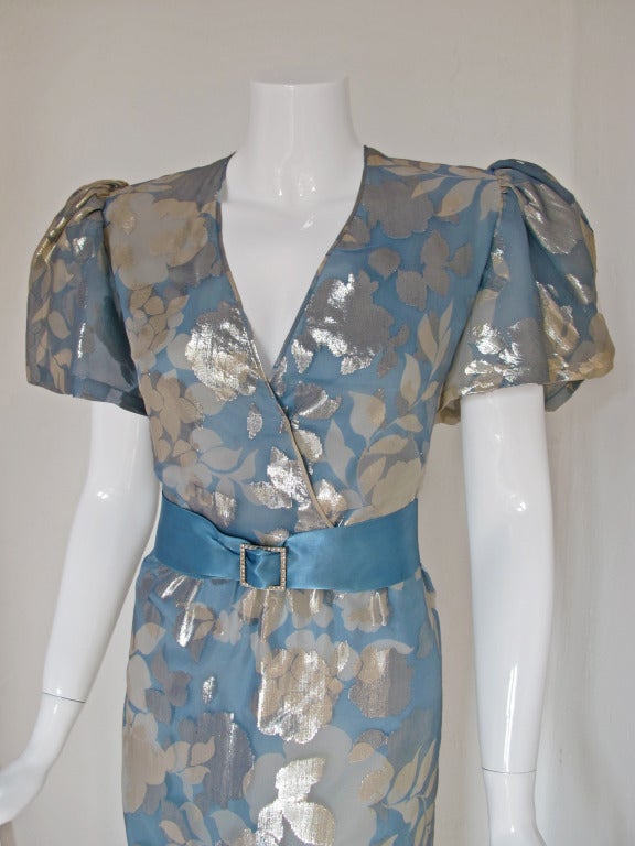 Ethereal 1980s Hanae Mori powder blue and silver silk lame gown with a ruffle bottom. The dress is made from two layers of silk - the top is blue and silver lame and the bottom is a watery blue silk. Features oversized shoulders, shoulder pads and a