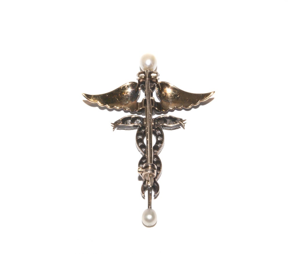 A Victorian Enamel Diamond Gold Caduceus Brooch