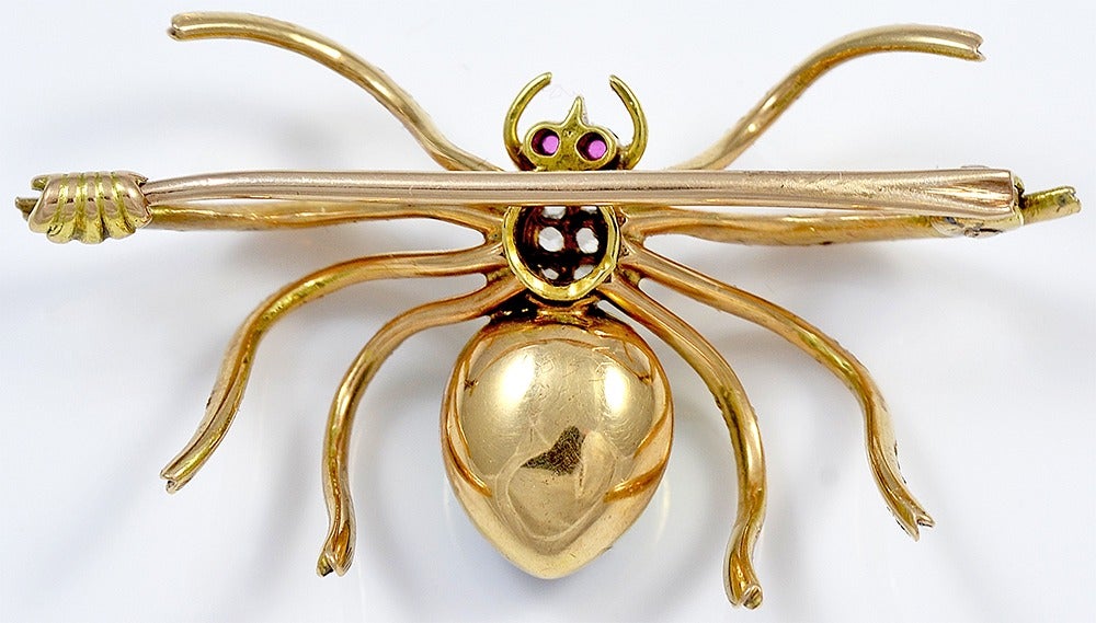 The thorax is set with six Diamonds and with Ruby eyes and the abdomen is attractively decorated with chevrons of blue, green and white Enamel.

Measuring 1 1/2 inches wide and 1 inch high, this 14kt Gold Brooch was made in the US circa the 1930's