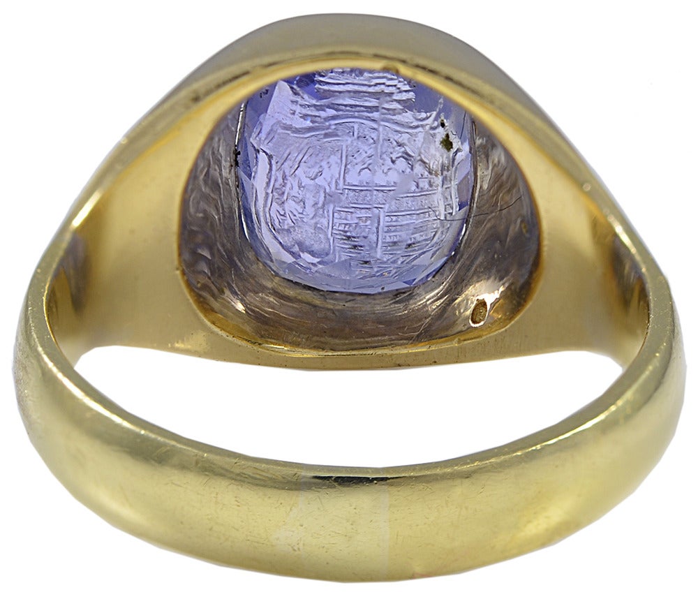 The pretty stone engraved with a Crown and Shield Crest and set in an unmarked 18 kt Gold mount.
A near perfect pinkie Ring for the right person.