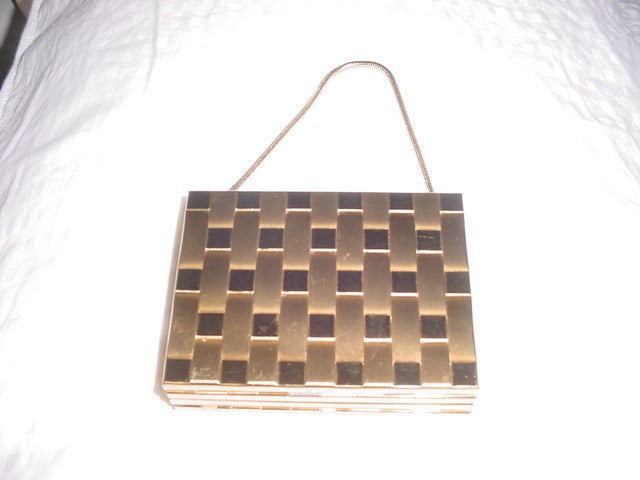 Vintage 1940s goldtone latticed vanity case. One side has a cigarette case, one side has mirror, lipstick holder and powder compact. Mirror has some slight discoloration.