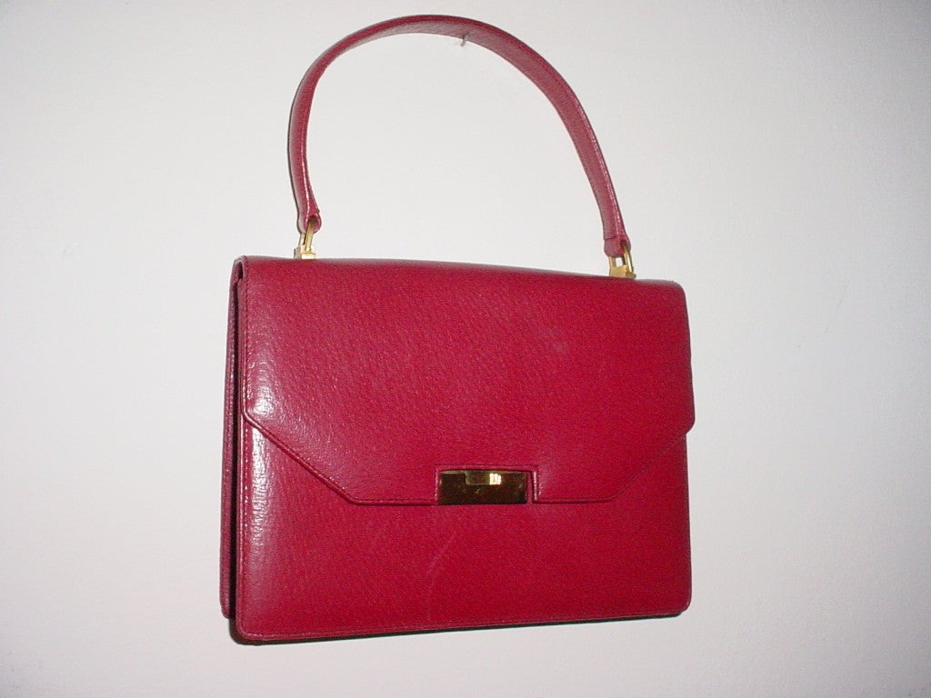 Beautiful 1950s red leather bag by Gucci. Made in Italy. Goldtone hardware. Excellent condition.