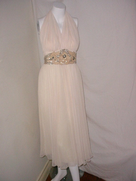 Vintage cream chiffon halter neck dress with sequin and bead trim.  By Ursula of Switzerland. Label is missing but there is an RN database number for Ursula. Store label from 
Elya-Kay Haddonfield New Jersey. Center back zipper. Excellent