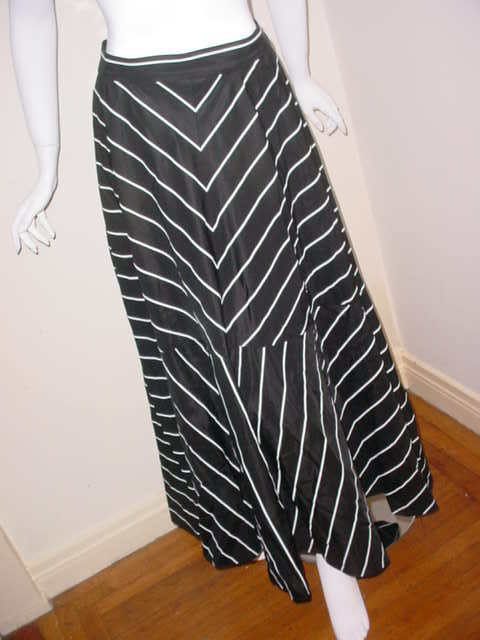 Vintage silk skirt by Jean-Louis Scherrer Couture. Excellent condition. Interesting design of black and white stripes. Label Jean-Louis Scherrer Couture Paris Made in France. Order number 04272. Labeled size 46. Fits a 30 inch waist. 40 inches long.