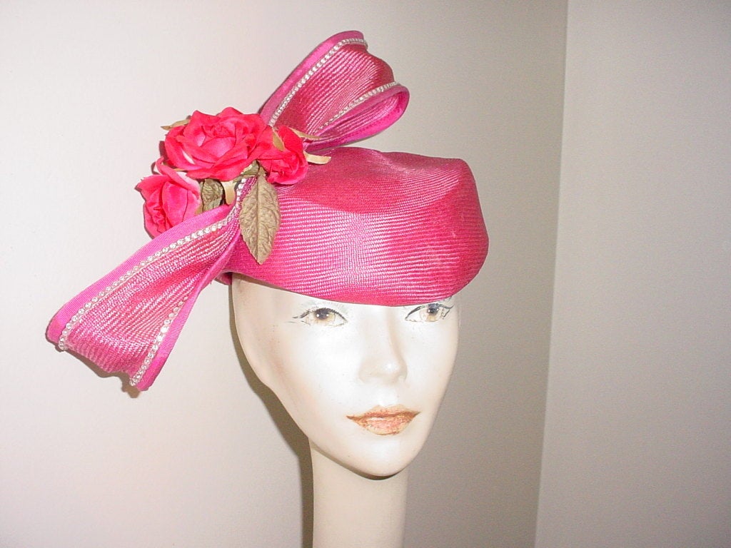 Vintage extravagant hat by Jack McConnell. Pink straw with flowers and huge bow with rhinestones.