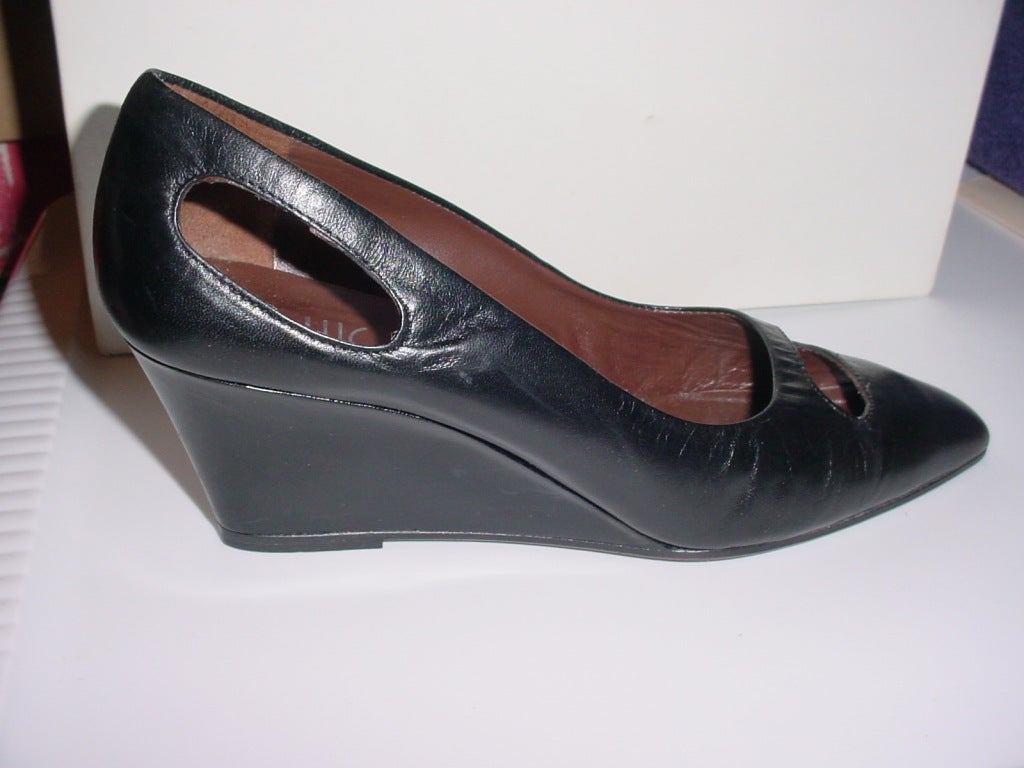 Vintage 1990s shoes by Luc Berjen Paris. Black leather with wedge heel and space-age style cutouts. Size 7.5 US. Heel of 2.5 inches, ball of 3 inches,9 3/4 inches long. Worn only once, excellent condition.