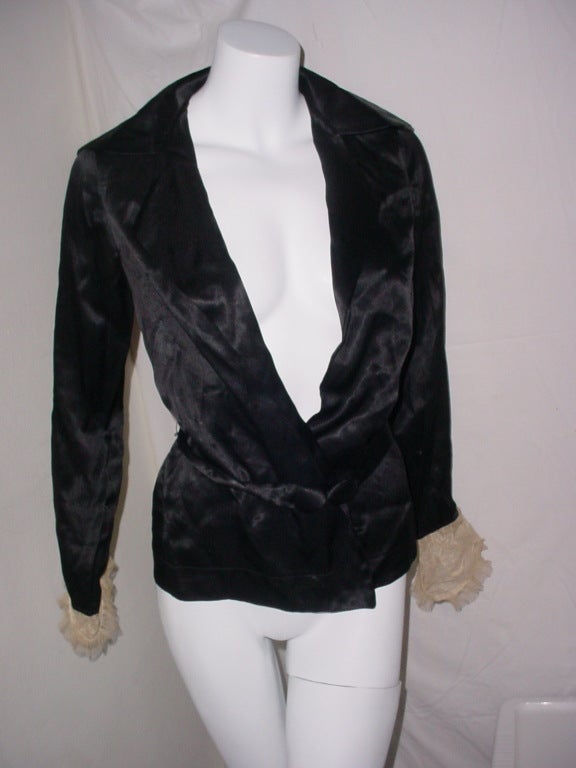 Vintage 1920s black satin jacket with belt and lace cuffs. Size small. Fits a 32 to 34 bust.