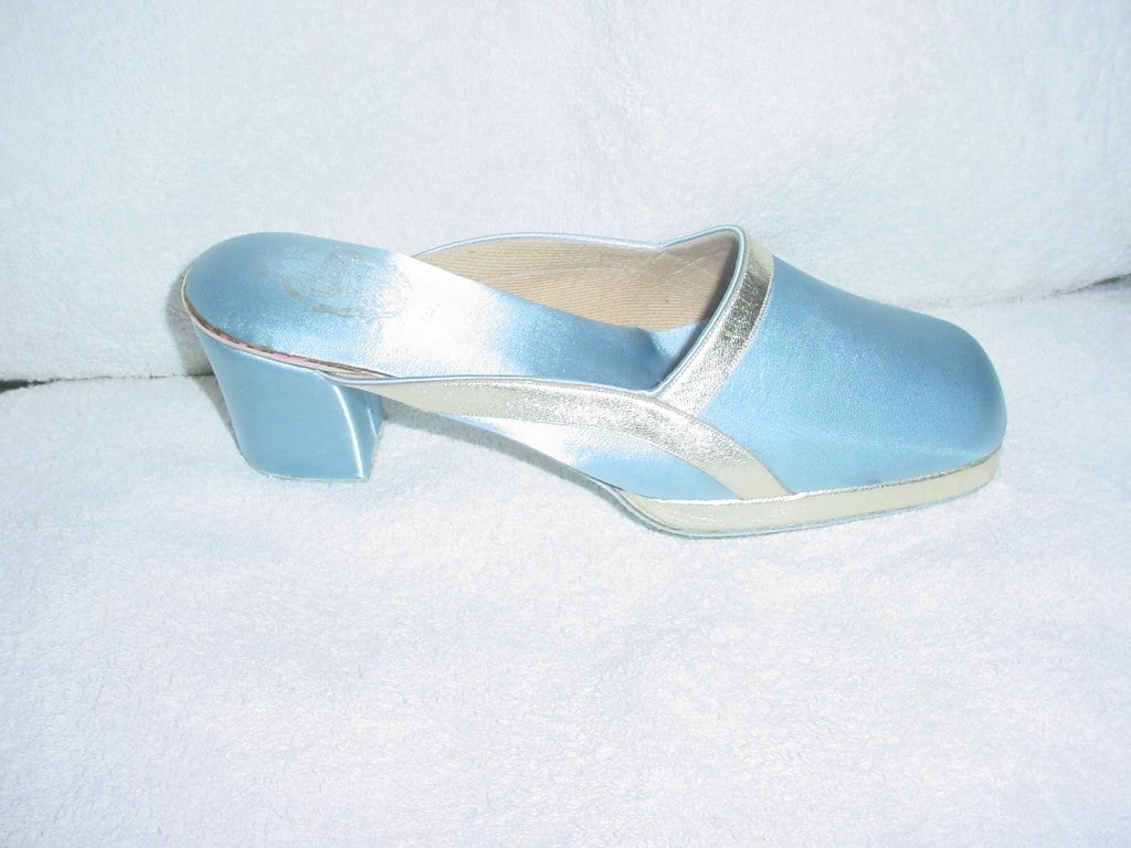 Vintage baby blue satin shoes with silver leather trim made in France. Unworn, excellent condition. With platform. Size 6 B. 9.5 inches long, 2.5 inch heel, ball of 3 inches.