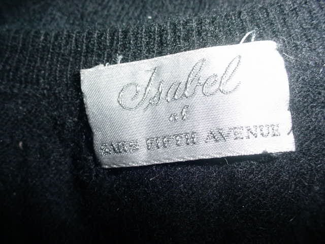 Late 1940s black cashmere cardigan by Isabel of Saks. Unworn, excellent condition. Fits up to a 40 inch bust.  Scottish cashmere. Isabel Kambert, an opera singer, who escaped Nazi Germany created the vogue for decorated cashmere sweaters. Her