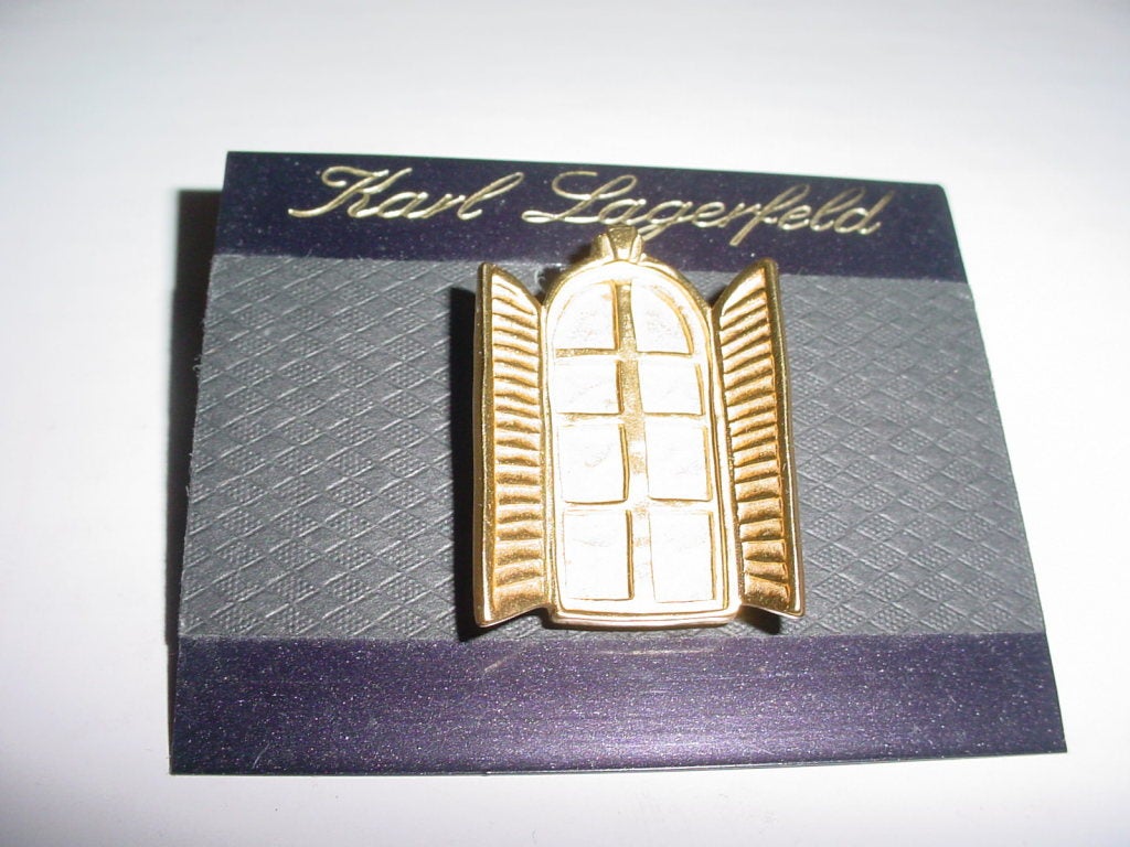 Vintage Karl Lagerfeld pin. Unworn on original card. Stud post back.  1 x 1.5 inches.