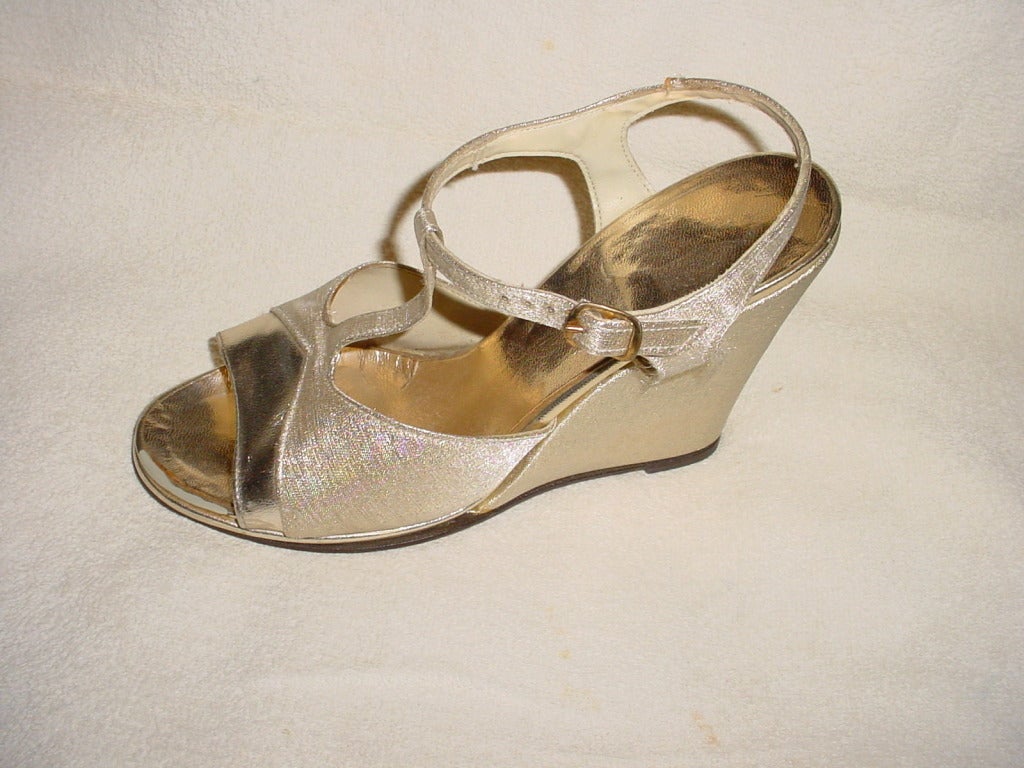 1970s gold lame' platform shoes by QualiCraft. Size 7 B.  9 in. long, ball of 3  1/8 in., heel of 4 in.