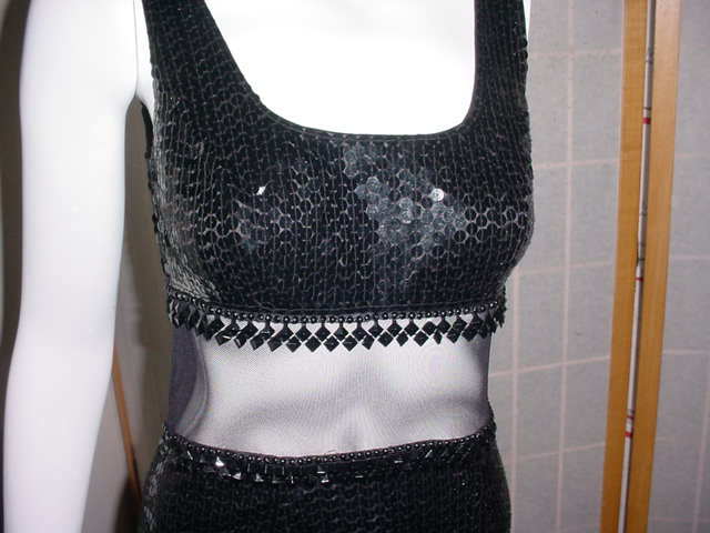 Long black sequin dress with sheer net inset and beads