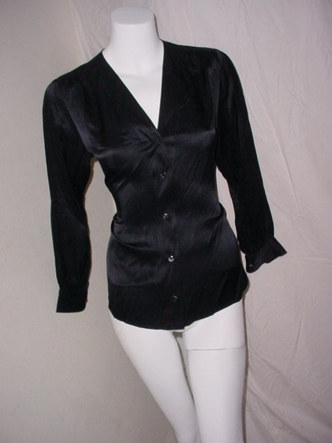 Late 60s Yves Saint Laurent Rive Gauche black silk blouse. Labeled size 36, fits up to a 36 bust, 25 inches long. Excellent condition.