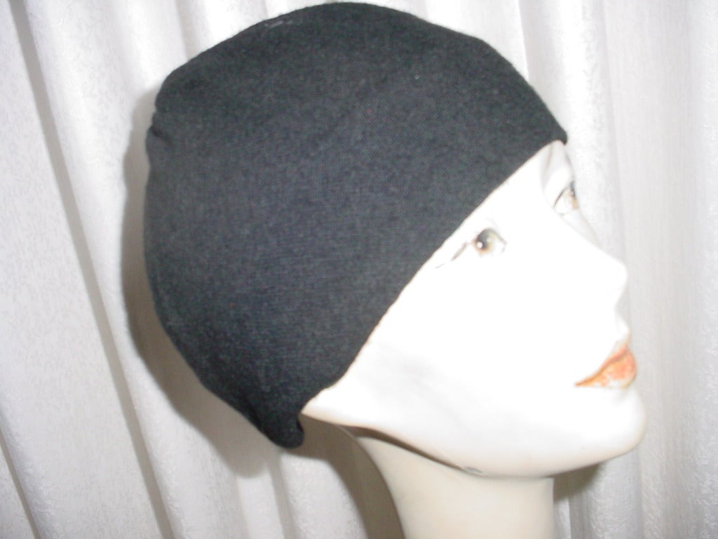 Vintage Mr John black wool hat. Clasps in back with metal clasp. Excellent unworn condition. Some stretch to fabric