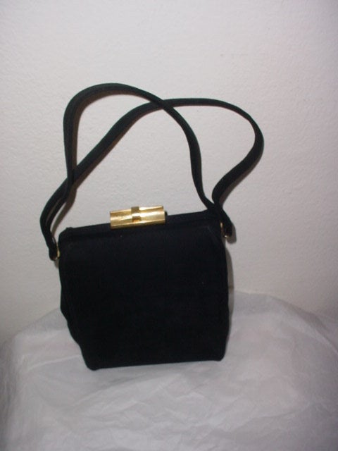 Vintage black suede 1940s bag with goldtone clasp. Beautiful black satin lining. A prime example of the finest in 40s handbag design. Excellent condition. Double handles.