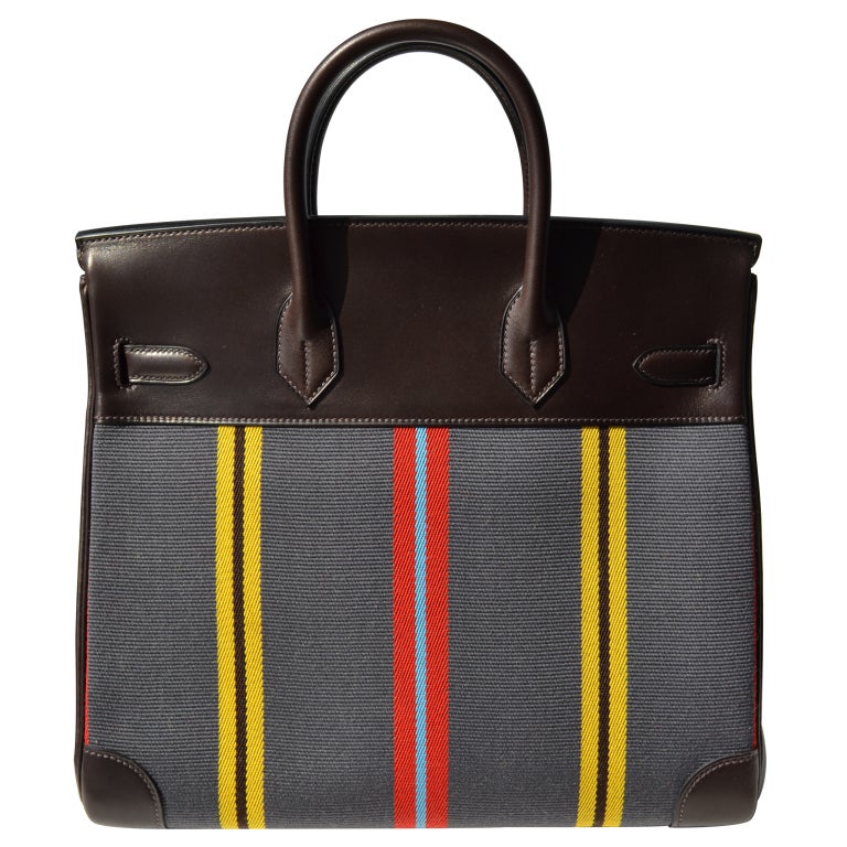A Combination of Lovely Color!

Creatéurs de Luxe offers this brand new 32cm Hermès Hac Handbag!

32cm Hermès Brown Swift Leather and Striped Grey, Yellow, Brown, Red and Blue Toile Hac Handbag | Palladium Hardware | P Stamp

The bag measures