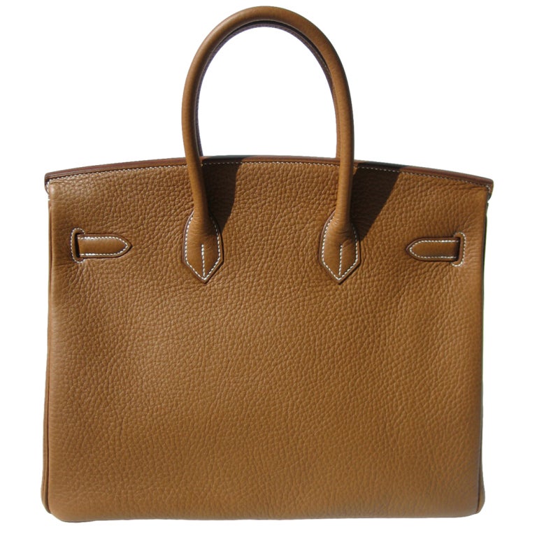 Brand New

Createurs de Luxe offers this brand new Hermes Birkin Handbag.

35cm Hermes Gold Taurillon Clemence Leather Birkin Handbag | White Stitching | Palladium Hardware | P Stamp

The bag measures 35cm / 14