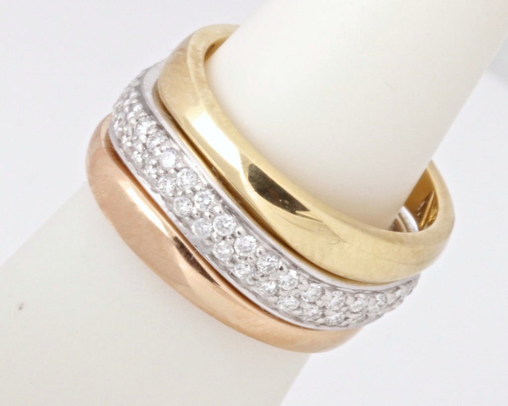 These rings from Cartier are elegant, versatile, and fun. You can stack them together in any number of ways. The white gold ring has a carat of super-white diamonds. Each ring is stamped with Cartier and a serial number. The rings are size 5. This