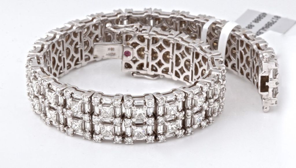 We scored big with this amazing bracelet from Roberto Coin. It is absolutely covered in spectacular white diamonds totaling over 15 carats. Emerald cut, round cut and princess cut white diamonds are presented in a geometric pattern reminiscent of