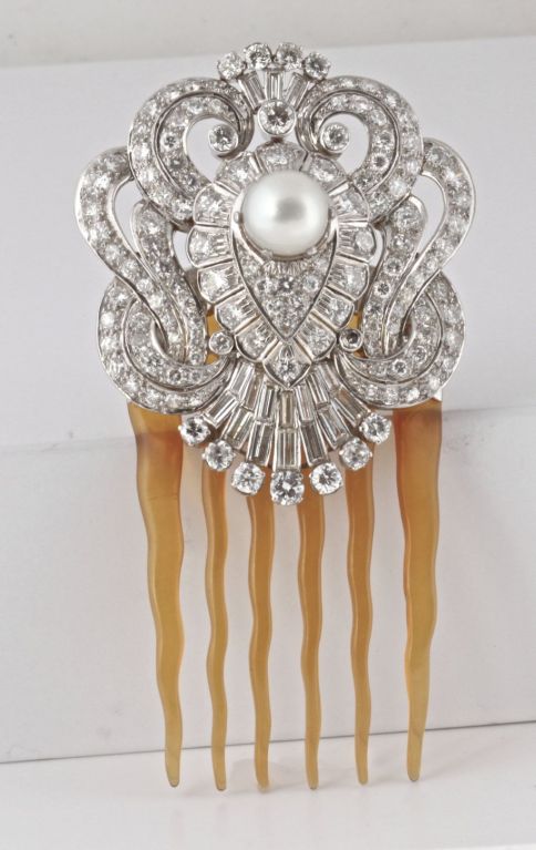 This is easily one of the most gorgeous hair pins I have ever seen. It is Art Deco with over 12 carats of incredible diamonds. The pearl in the center is a beautiful South Sea Cultured pearl and it is a beauty; creamy white with hints of pink. The