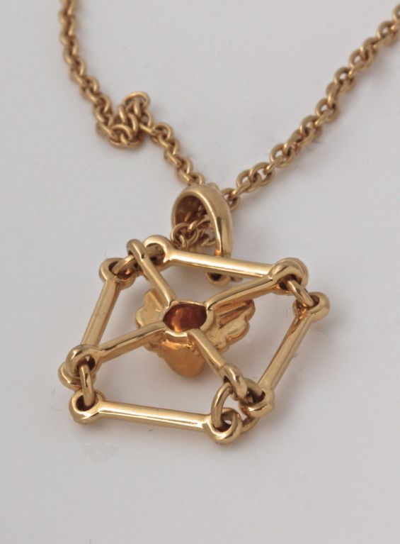 This is a delicate pendant necklace from the cool folks at Carrera Y Carrera. There's something interesting about the way the cherub is suspended by the gold frame. It's structural and a little industrial, while being sweet and reverential about the