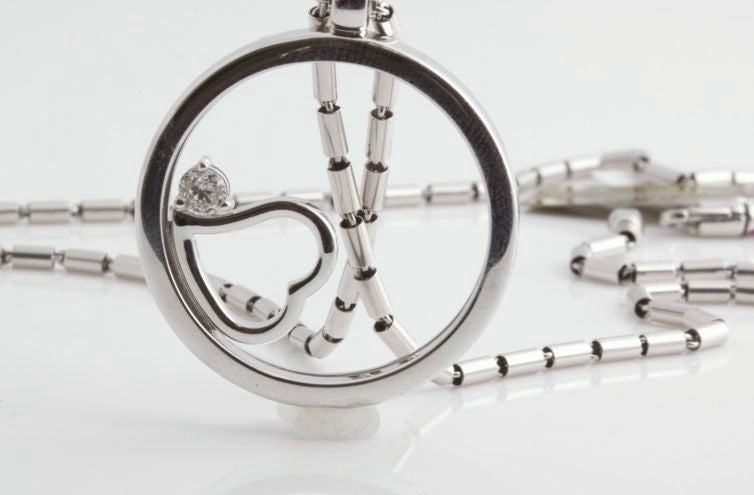 This is a wonderful necklace from Roberto Coin. A large circle of white gold encompasses a beautiful heart and an amazing diamond. The heart can actually rotate within the circle. The chain is really fantastic. Look at the links. Each one is a