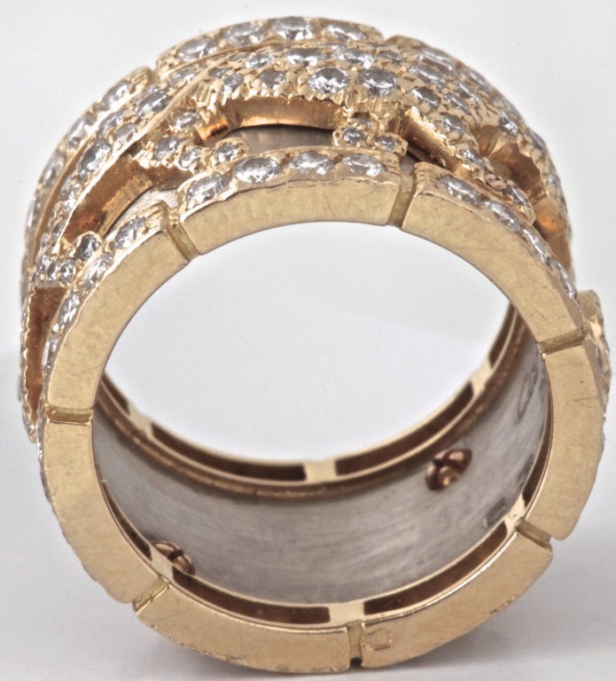 This is the famous Panther Ring from Cartier. It's is an iconic piece immediately recognizable as Cartier. This one is in Excellent Condition and it is white and yellow gold making it extremely versatile. The diamond encrusted panthers are done in