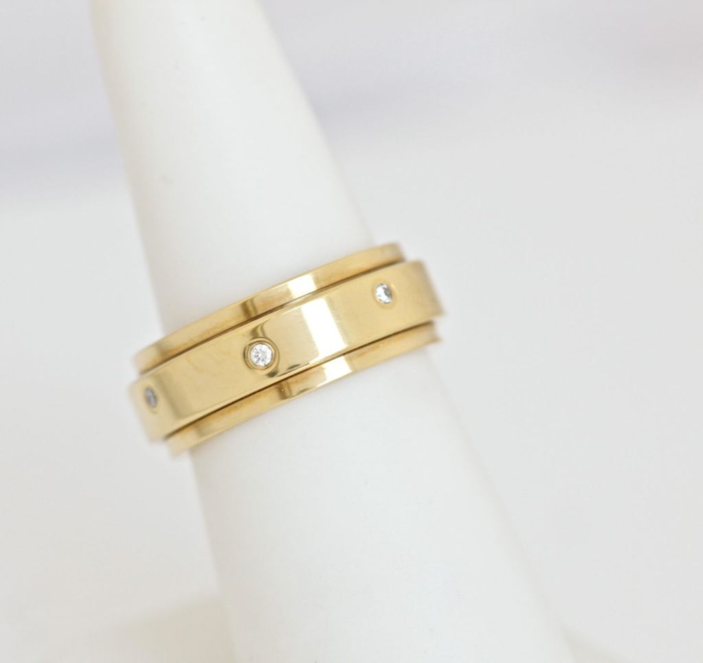 This is the thin Piaget Bandeau ring.The center of the ring spins around the outside, so it's good for people who fidget (like me).

WEIGHT: 9 Grams

METAL: 18K yellow gold

SIZE: 6.5

WIDTH OF BAND: .7 cm
 
NUMBER OF DIAMONDS: 7

WEIGHT