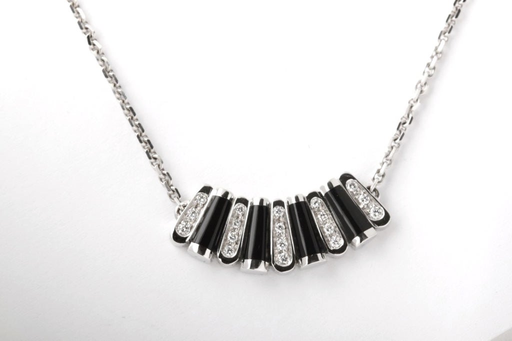 This is a beautiful onyx and pave diamond pendant necklace from Asprey. It is composed of 18K white gold with 18 pave diamonds, and four black onyx bars. It weighs 14 grams and it is stamped 