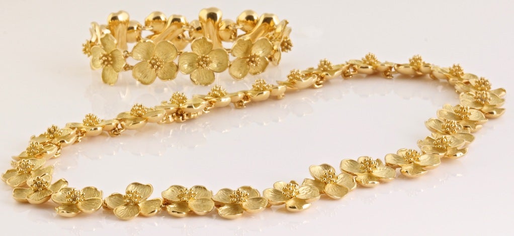 This Tiffany & Co. necklace and bracelet are designed as textured gold dogwood flowers. The width of the bracelet and necklace is .6 inches (1.8cm). The length of the necklace is 16.5 inches (43cm). The bracelet is 7 inches (17.5cm). The total